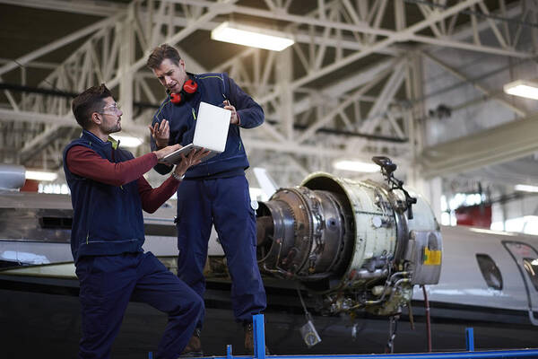 Working Art Print featuring the photograph Aircraft mechanics in the hangar #4 by Extreme-photographer