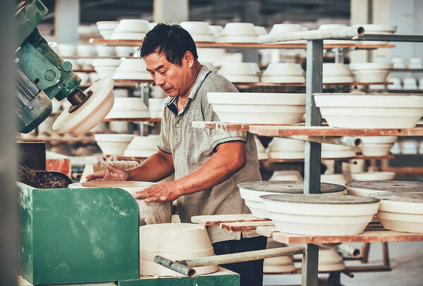 Art And Craft Art Print featuring the photograph A Senior Staff Polishing Porcelain Clay in Factory by Chalffy