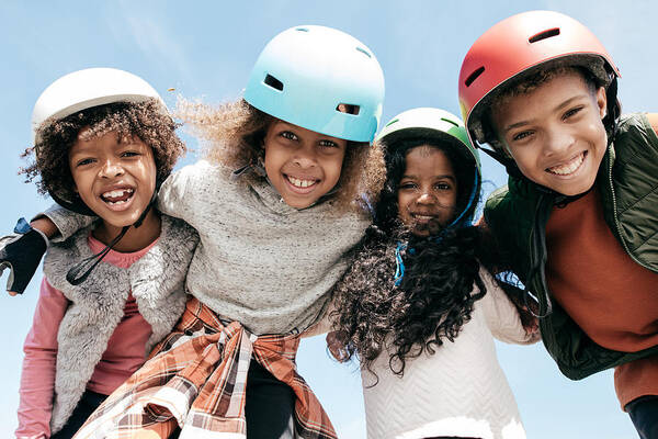 Outdoors Art Print featuring the photograph Adorable multi-ethnic group of kids wearing helmets and looking to the camera with happiness by Kate_sept2004