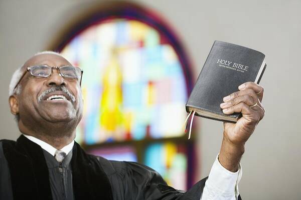 Human Arm Art Print featuring the photograph African American Reverend holding up Bible by Hill Street Studios