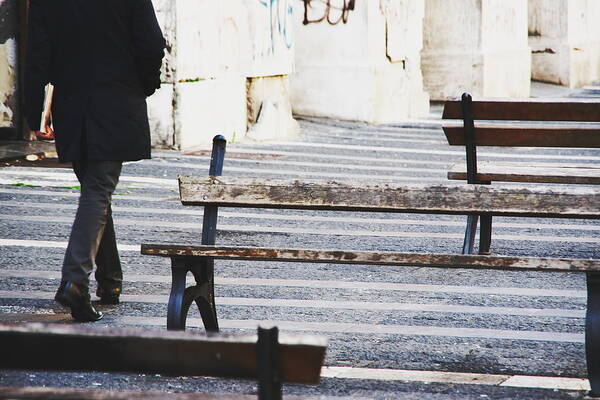 People Art Print featuring the photograph Businessman walking outdoors between benches by Maurizio Siani