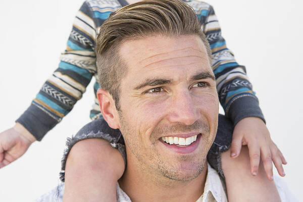 People Art Print featuring the photograph Close up of Caucasian father holding son on shoulders by Sam Diephuis