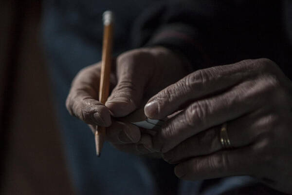 Working Art Print featuring the photograph Close up of male hands holding a pencil and piece of wood by Raphye Alexius