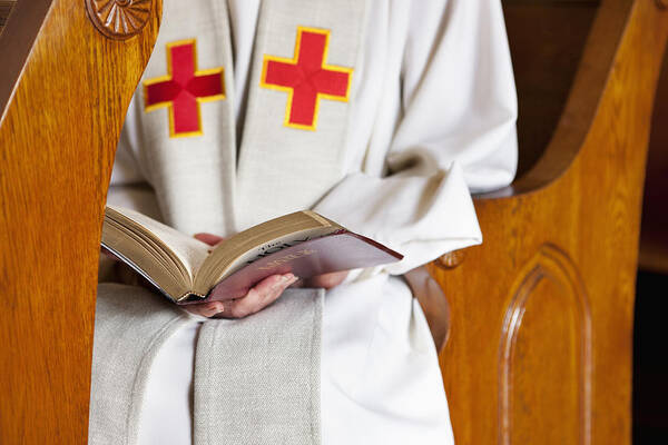 Pew Art Print featuring the photograph Close up of priest reading Bible by Robert Nicholas