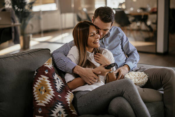 Young Men Art Print featuring the photograph Couple at home watching TV by Milos Dimic