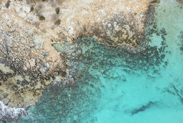 Rocky Beach Art Print featuring the photograph Drone aerial of rocky sea coast with transparent turquoise water. Seascape top view by Michalakis Ppalis