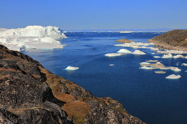 Tranquility Art Print featuring the photograph Elevated view from rocky terrain at huge icebergs by Rainer Grosskopf