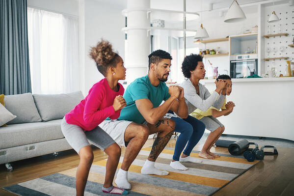 Prevention Art Print featuring the photograph Family exercising at home by Gilaxia
