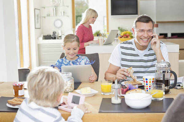 Domestic Room Art Print featuring the photograph Family using technology at breakfast by Chris Ryan