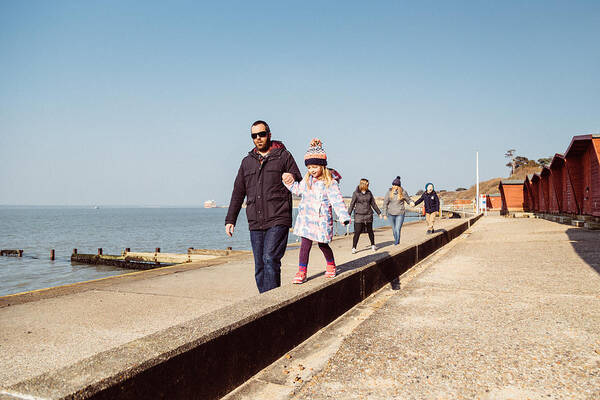 Child Art Print featuring the photograph Family walk along the coast by s0ulsurfing - Jason Swain