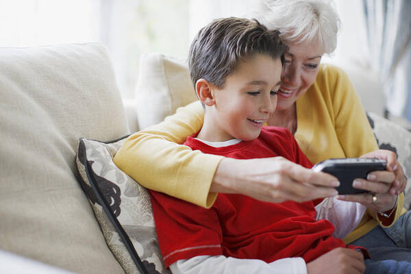 Explaining Art Print featuring the photograph Grandmother and grandson playing video game by Paul Bradbury