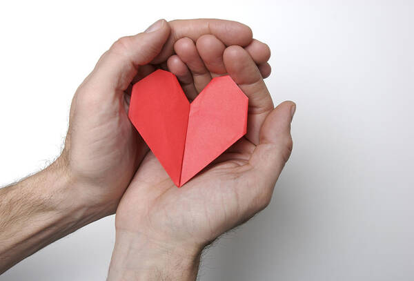 Care Art Print featuring the photograph Hands Holding Folded Origami Heart White Background by PeskyMonkey
