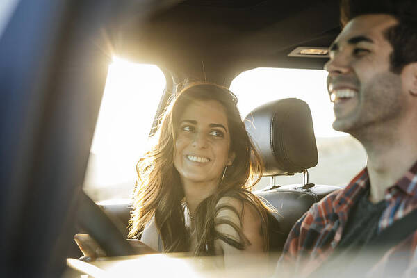 Mid Adult Art Print featuring the photograph Happy couple driving in car on road trip by The Good Brigade