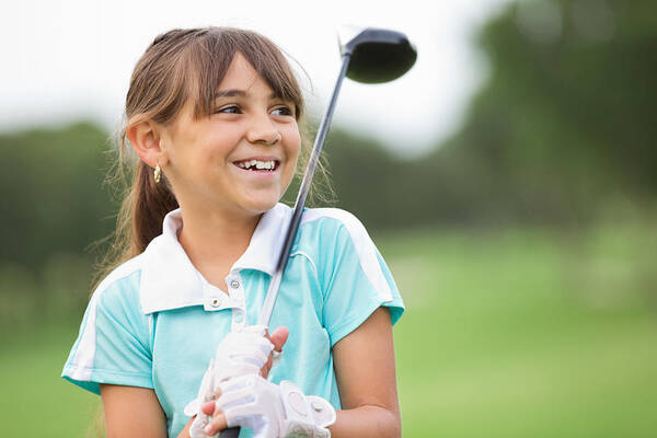 Putting Green Art Print featuring the photograph Happy little girl playing golf at country club by SDI Productions