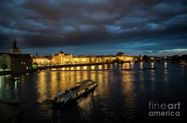 Architecture Art Print featuring the photograph Illuminated Moldova River With Ship And Buildings In The Night In Prague In The Czech Republic by Andreas Berthold