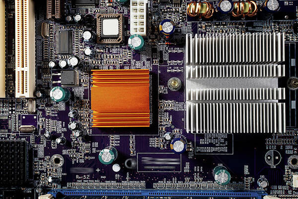 Computer Art Print featuring the photograph Mainboard of a pc with electronic components. by Bernhard Schaffer