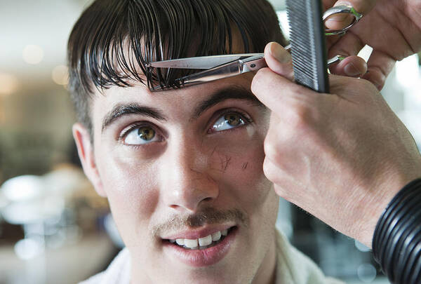 Young Men Art Print featuring the photograph Man having his fringe cut by hairdresser by Dimitri Otis