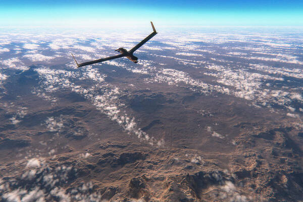 Concepts & Topics Art Print featuring the photograph Military surveillance drone flying over rocky deserts by Gremlin