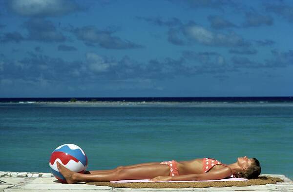 Fashion Art Print featuring the photograph Model Lying on the Beach in a Polka Dot Bikini by Mike Reinhardt