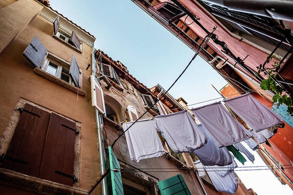 Croatia Art Print featuring the photograph Narrow Alley With Old Houses And Freshly Washed Laundry In The City Of Rovinj In Croatia by Andreas Berthold