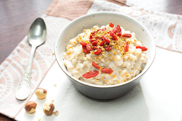 Breakfast Art Print featuring the photograph Oatmeal porridge with goji berries by Arx0nt
