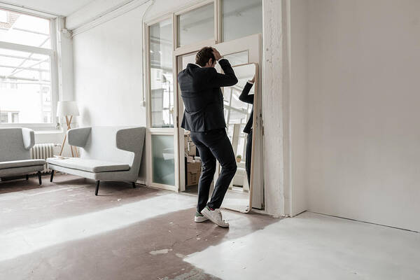 Corporate Business Art Print featuring the photograph Rear view of businessman looking in mirror by Westend61