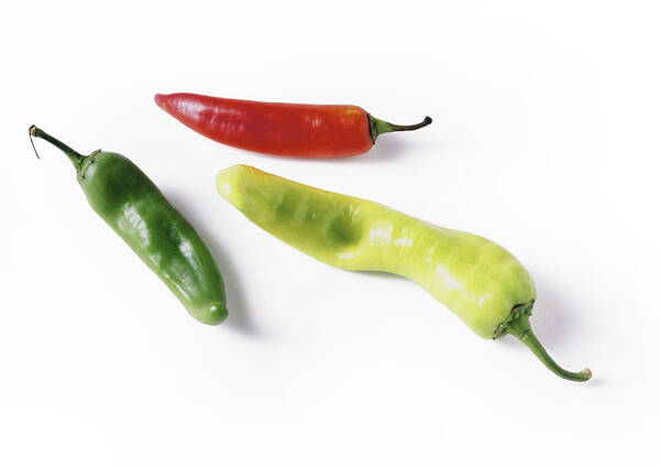 White Background Art Print featuring the photograph Red and green chili peppers, full length by Isabelle Rozenbaum