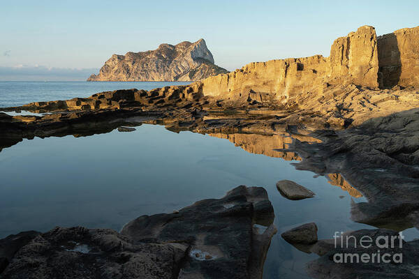 Mediterranean Art Print featuring the photograph Reflection of rocks in the calm Mediterranean Sea at sunrise 1 by Adriana Mueller