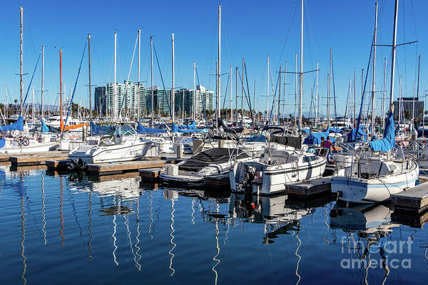 Sailboats Art Print featuring the photograph Reflections of sailboats in blue water by Roslyn Wilkins