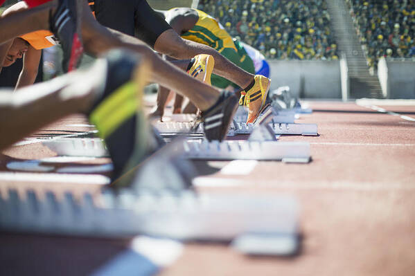 Young Men Art Print featuring the photograph Runners poised at starting blocks on track by Caia Image