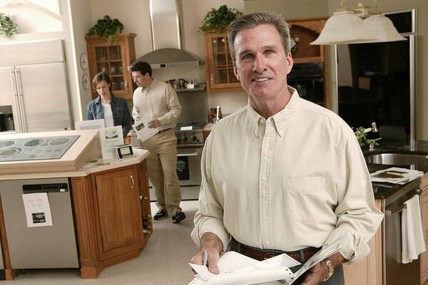 White People Art Print featuring the photograph Salesman in home improvement store by Comstock Images