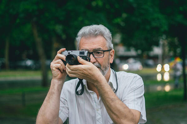 Retirement Art Print featuring the photograph Senior photographer by Freemixer