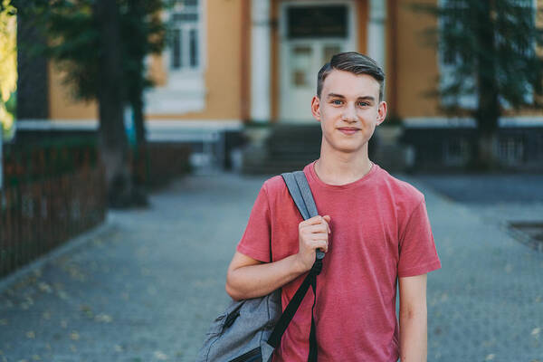 Bulgaria Art Print featuring the photograph Smiling schoolboy in the schoolyard by Martin-dm