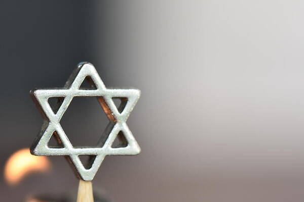 Holiday Art Print featuring the photograph Star of David on a candle background by tzahiV