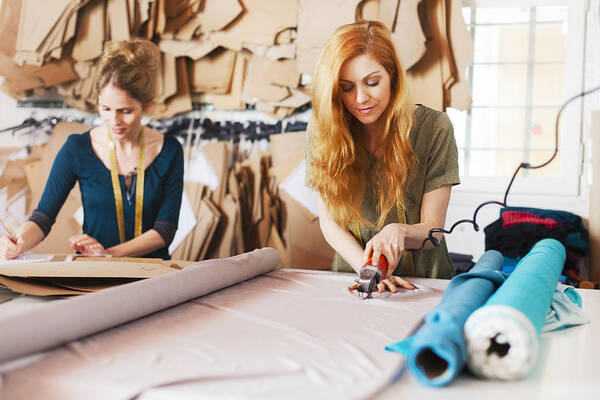 Working Art Print featuring the photograph Tailor studio, fashion designers at work. by Tempura