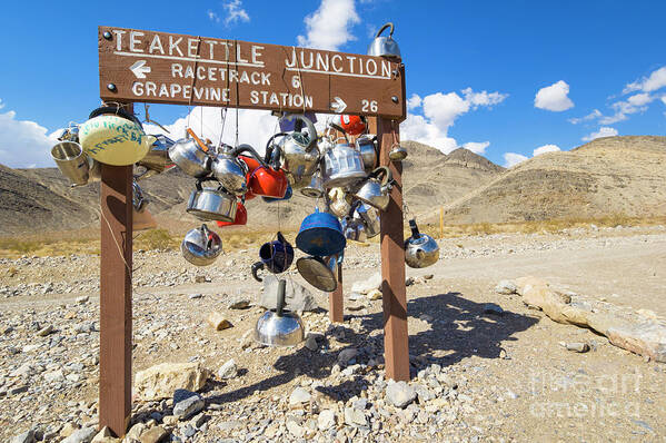 Road Art Print featuring the photograph Teakettle Junction and road sign covered by kettles and pans, Death Valley National Park, California by Neale And Judith Clark