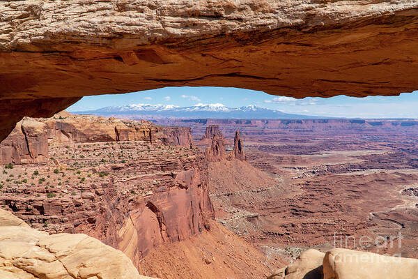 Canyonlands National Park Art Print featuring the photograph The Washerwoman Arch is framed by the Mesa Arch at Canyonlands N by William Kuta