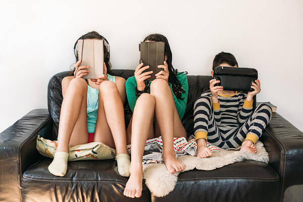 Internet Art Print featuring the photograph Three Kids With Electronic Devices On A Sofa by Os Tartarouchos