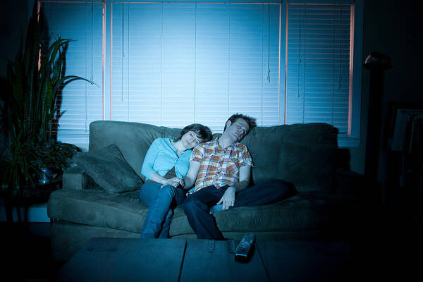 Young Men Art Print featuring the photograph Young couple fallen asleep in front of tv by Image Source