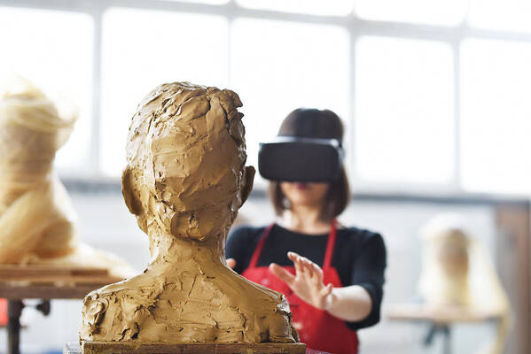 Working Art Print featuring the photograph Young Female Sculptor is working with VR in her studio by Baranozdemir