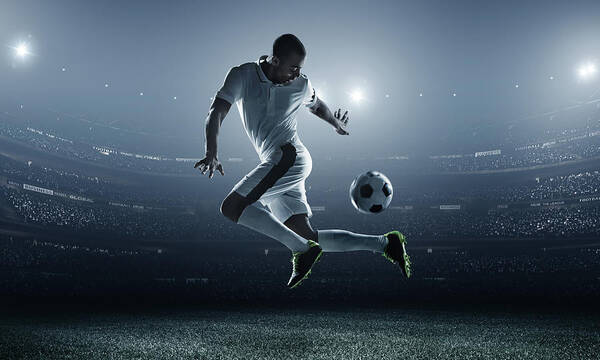 Goal Art Print featuring the photograph Soccer Player Kicking Ball In Stadium by Dmytro Aksonov