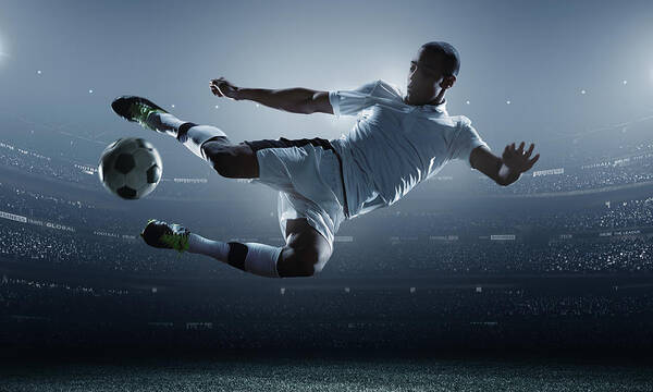 Goal Art Print featuring the photograph Soccer Player Kicking Ball In Stadium by Dmytro Aksonov Goal Art Print featuring the photograph Soccer Player Kicking Ball In Stadium by Dmytro Aksonov