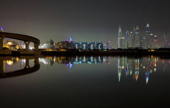 Dubai Art Print featuring the photograph Dubai city skyline night time reflection by Andy Myatt