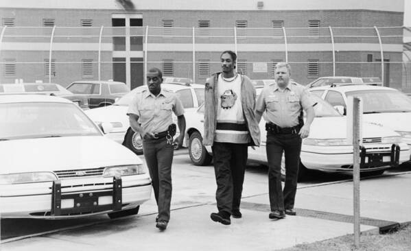 Following Art Print featuring the photograph Snoop Doggy Dogg In Police Custody by Hulton Archive