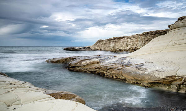 Seascape Art Print featuring the photograph Rocky seacoast and waves splashing on with white rocks by Michalakis Ppalis