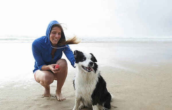 Pets Art Print featuring the photograph Woman and dog on beach. by Dougal Waters