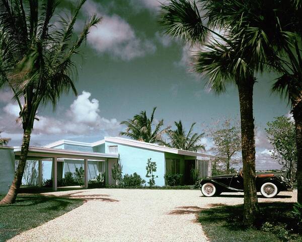 Nobodyoutdoorsdaytimehousedwellingdrivewayretroold-fashionedvintagevintage Cartransportationcarmotor Vehicleautomobilevehicletreemiamimiami-dade Countyfloridausanorth Americasouthern United Statesnorth American Atlantic Coastrobert M. Littlearchitecture #condenasthouse&gardenphotograph November 1st 1955 Art Print featuring the photograph A Vintage Car Parked Outside A Blue House by Tom Leonard