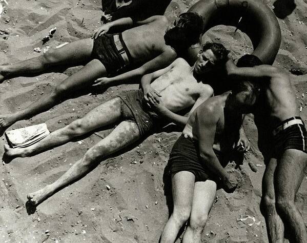 Outdoor Living Art Print featuring the photograph Boys Lying On The Beach At Coney Island In New by Lusha Nelson