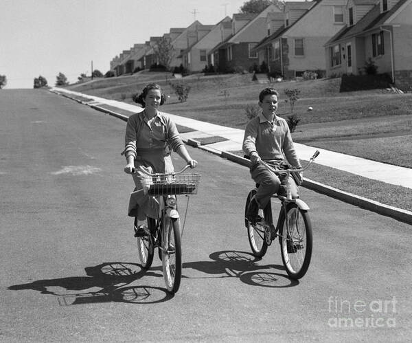 1950s Art Print featuring the photograph Teen Boy And Girl Riding Bikes, C.1950s by H. Armstrong Roberts/ClassicStock