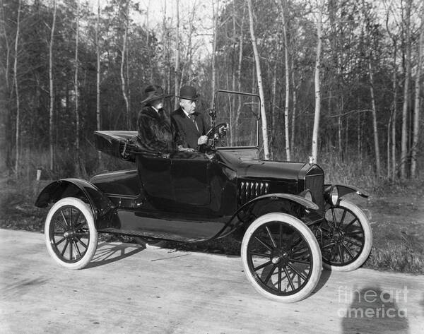 Mature Adult Art Print featuring the photograph Couple In 1920 Open Model T Runabout by Bettmann